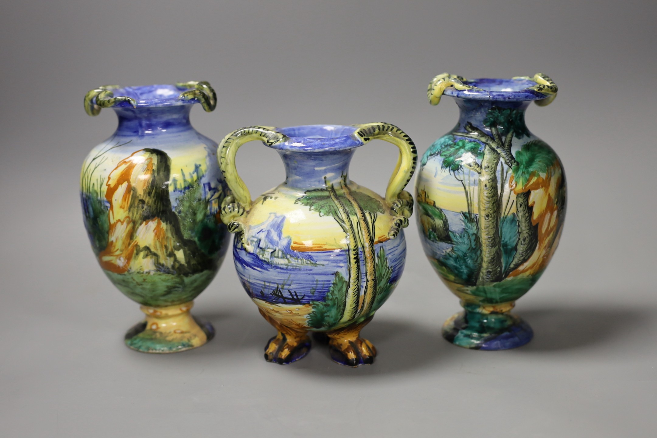 A pair of Italian maiolica vases, by Cantagalli and a similar two handled vase, cockerel marks, pair 17 cms high